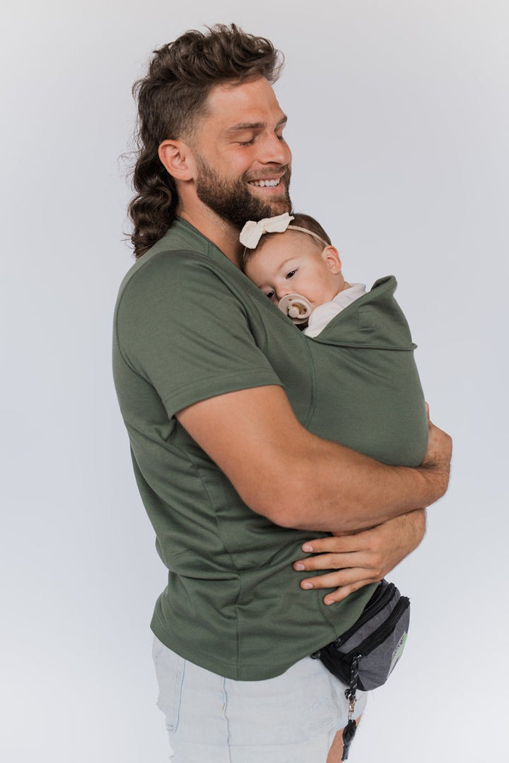 Folded comfort carrier babywearing shirt ready for travel and daily infant care use.