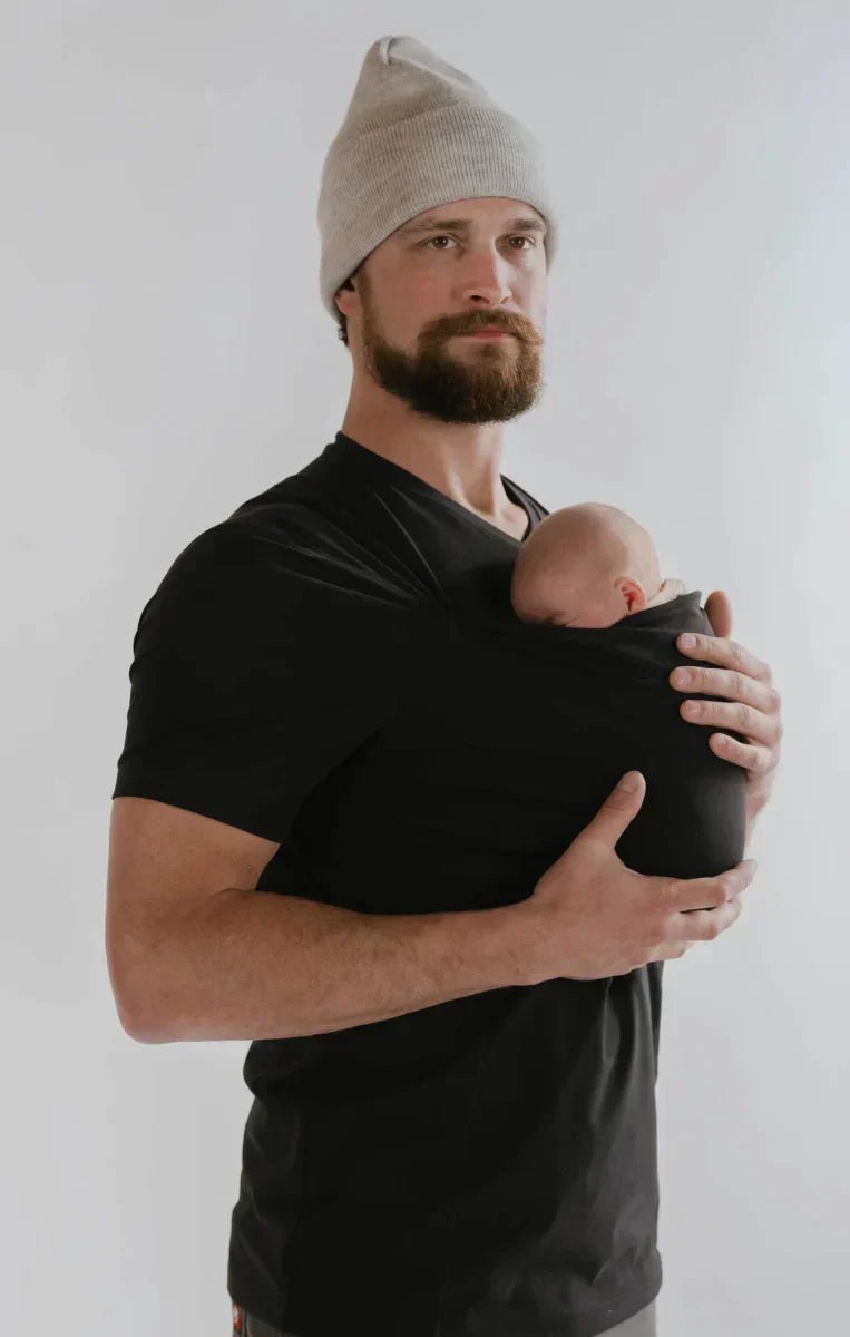 Parent wearing breathable baby apparel sling for easy infant soothing and carrying.