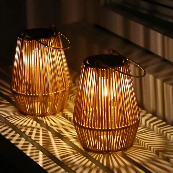 Waterproof outdoor lantern casting warm LED light on a garden table