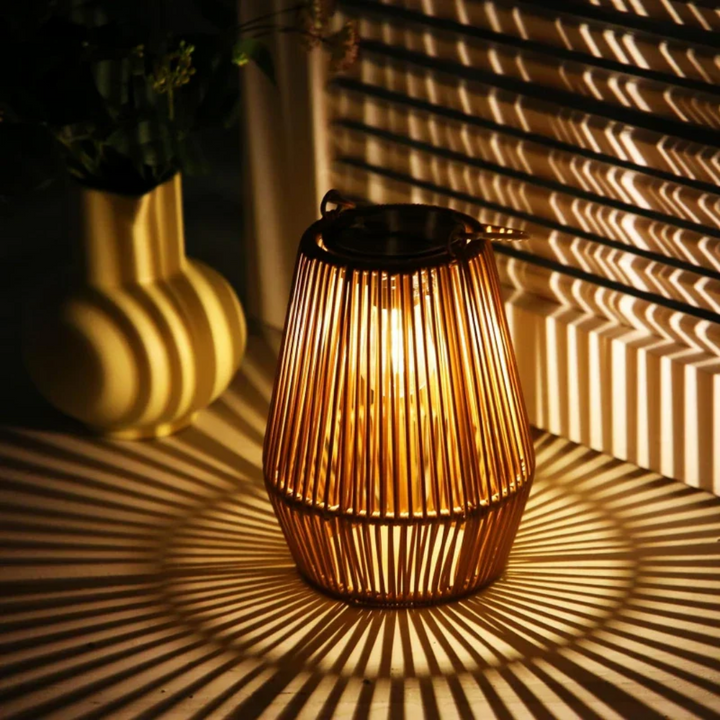 Handwoven waterproof solar garden lantern glowing on a tabletop