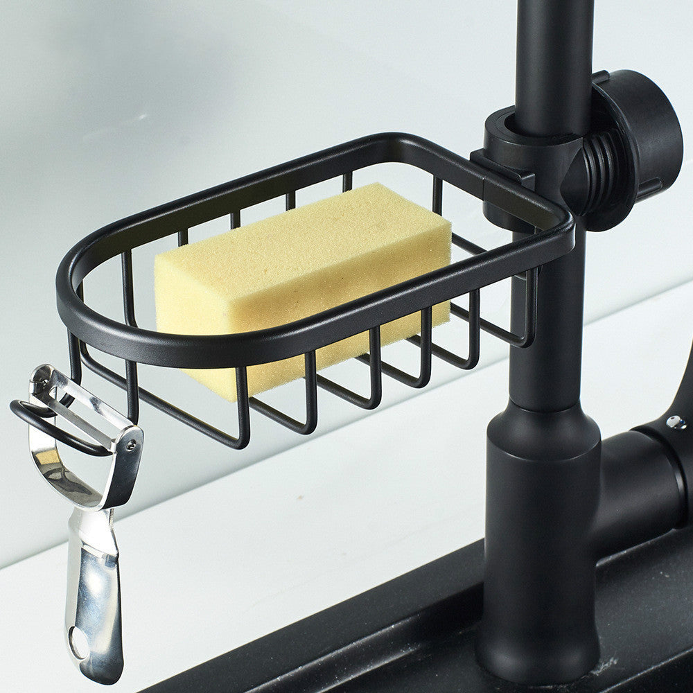 Black hanging shower soap dish holding a yellow sponge mounted on a shower rail