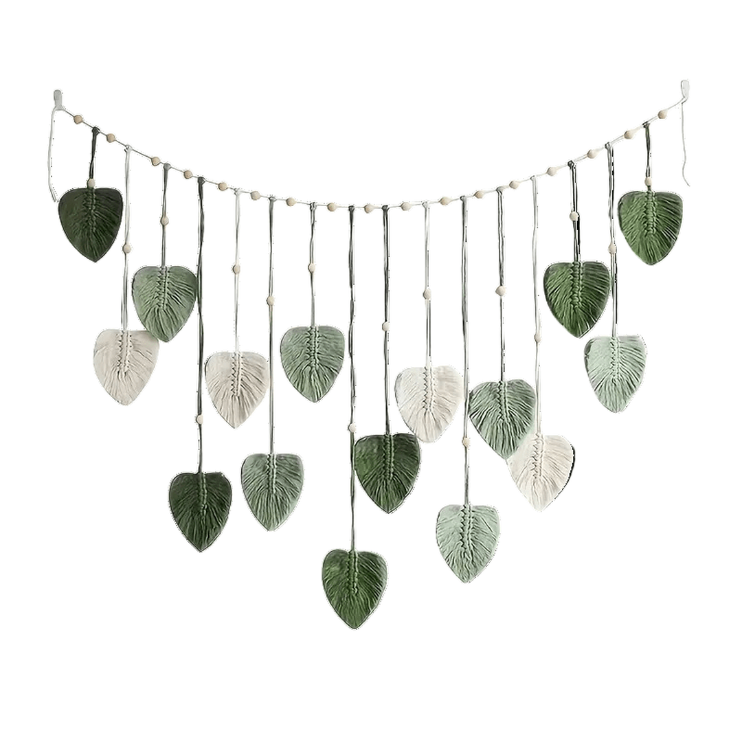 Hanging wall art with green and cream leaf pendants and beads against a white background