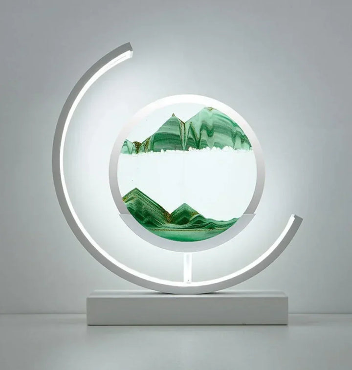 Close-up of flowing sand art inside a glowing circular desk lamp and night light