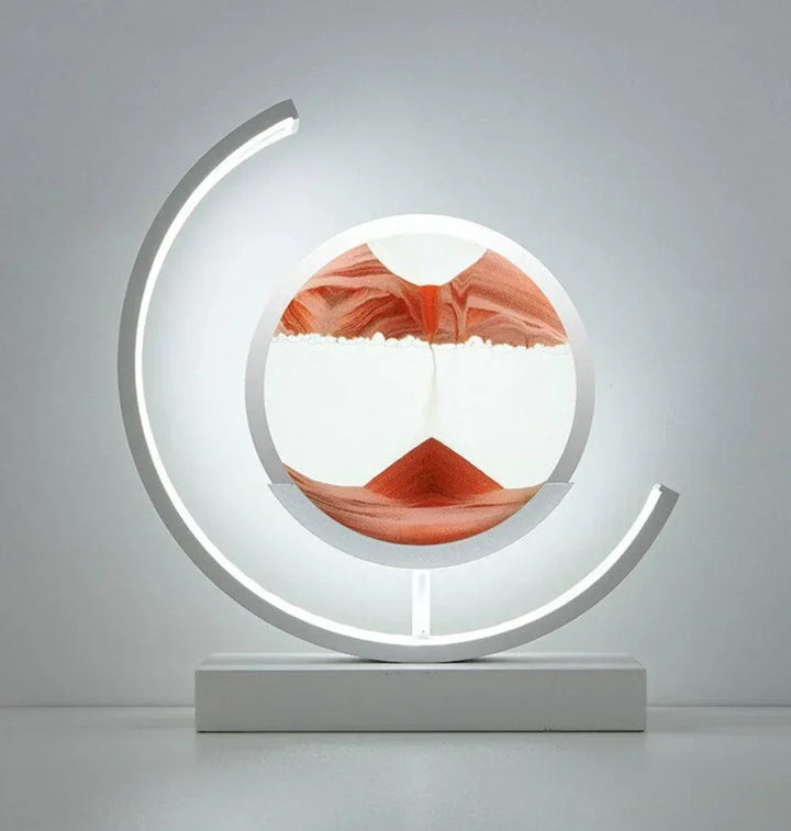 Decorative sandscape table lamp casting a warm and soothing glow on a surface