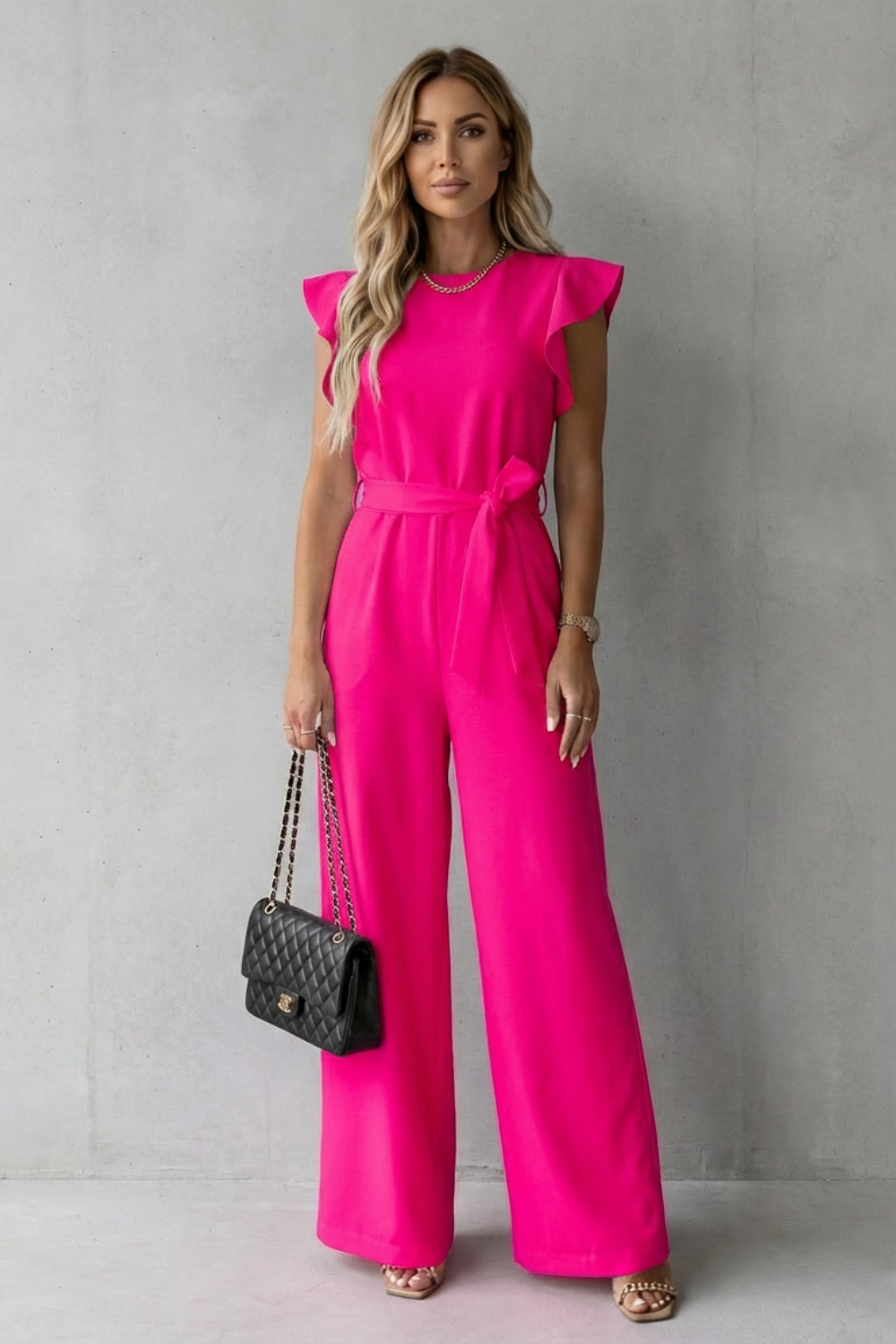 Close-up of ruffle sleeve detail on women's chic wide-leg one-piece jumpsuit fashion