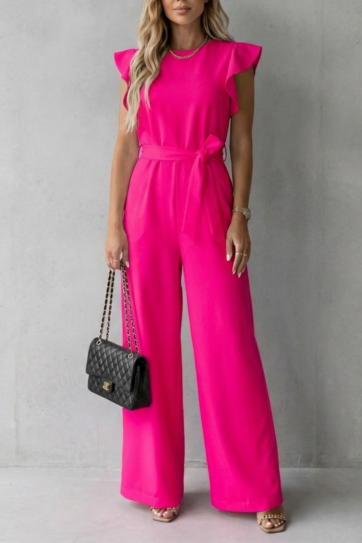 Side profile of women's sophisticated belted jumpsuit with flowing wide-leg silhouette