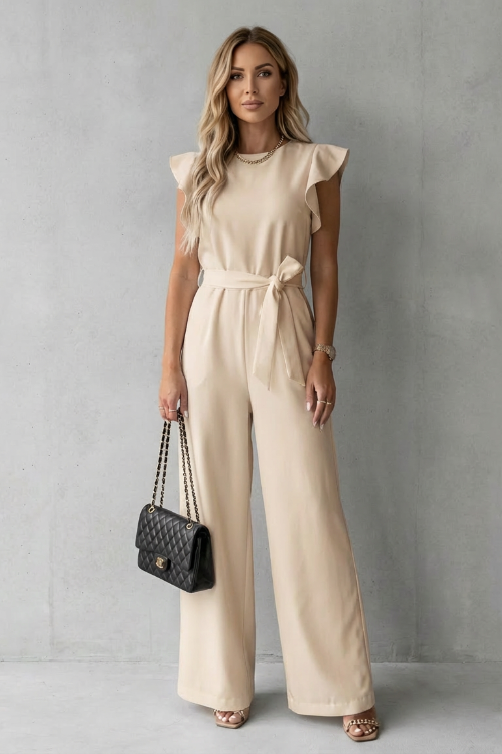 Back view of elegant women's evening wear jumpsuit featuring tailored waistband