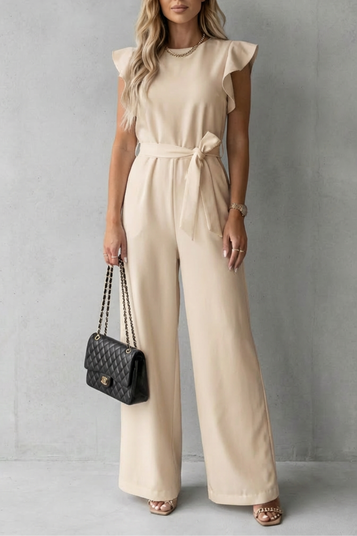 Model wearing stylish office-ready wide-leg jumpsuit with dramatic ruffle sleeves