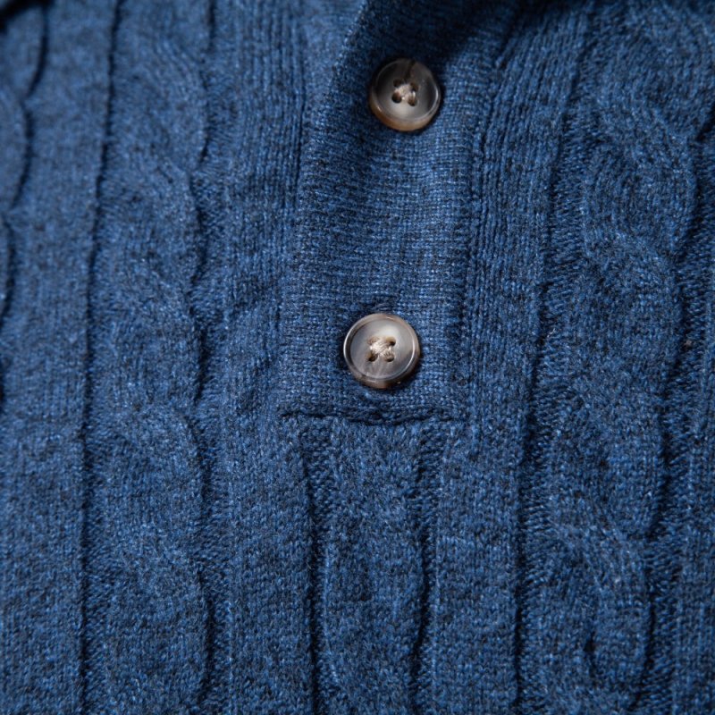 Hemline and fine stitch detail of men's cable knit fashion polo