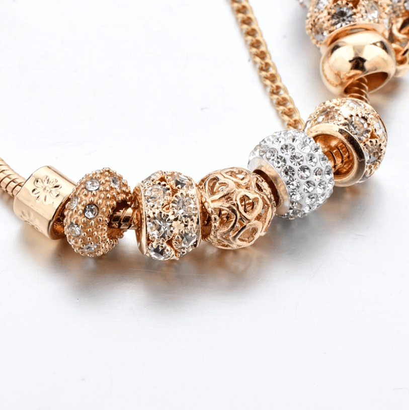 Gold tone women sparkling heart charm bracelet close up view