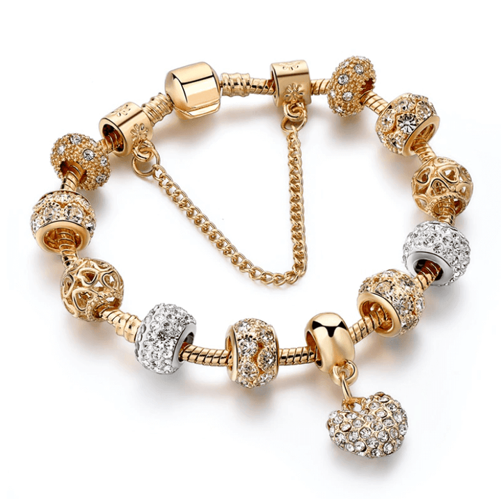 Women's gold tone charm bracelet with crystal beads and heart pendant