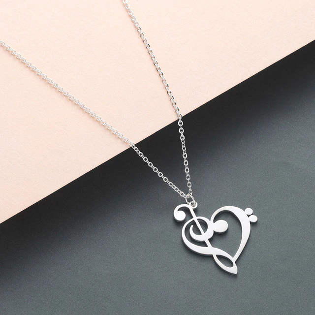 Silver music note heart pendant necklace on a clean white background