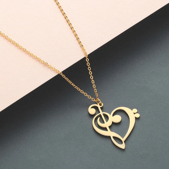Gold heart shaped musical pendant necklace showcasing detailed notes