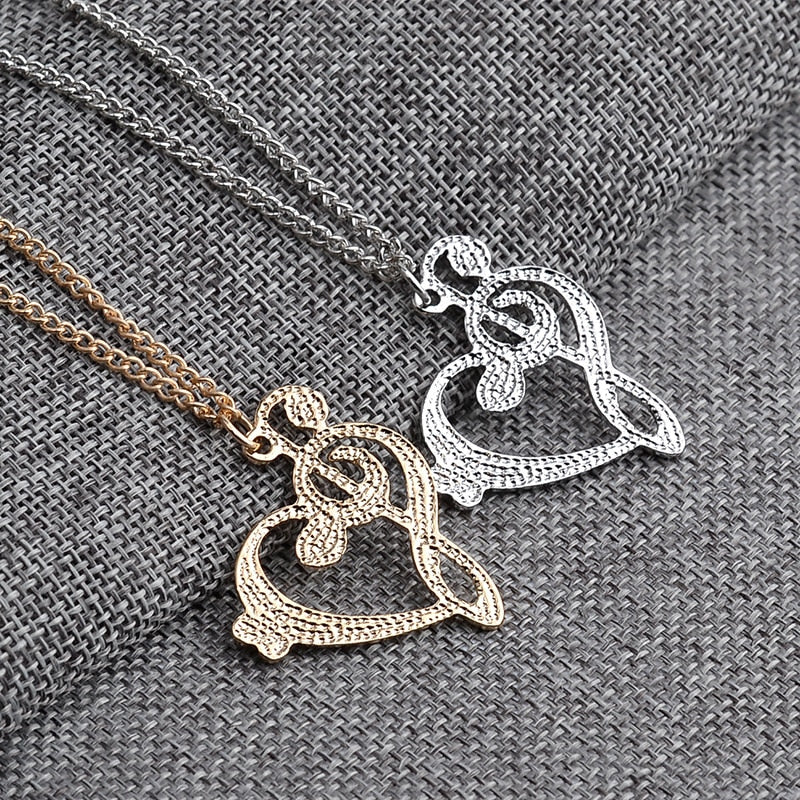Back view of silver and gold musical heart pendants