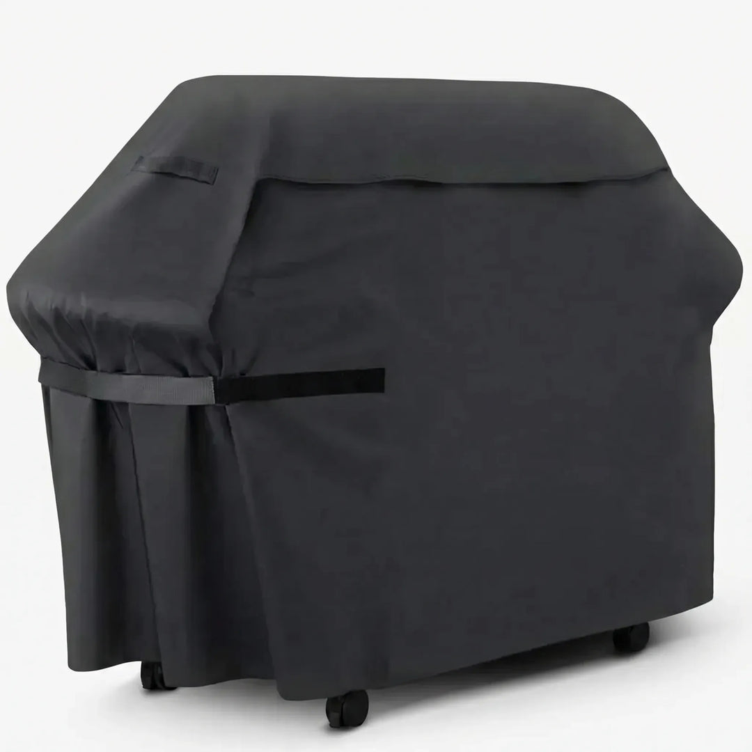 Heavy-duty black barbecue grill cover fitted securely over an outdoor gas grill