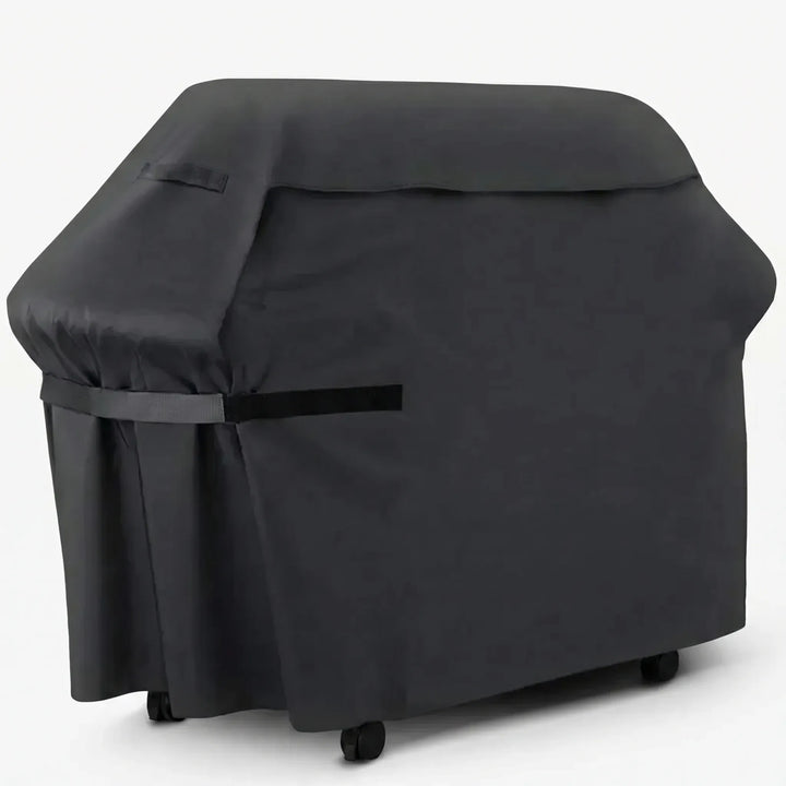 Heavy-duty black barbecue grill cover fitted securely over an outdoor gas grill