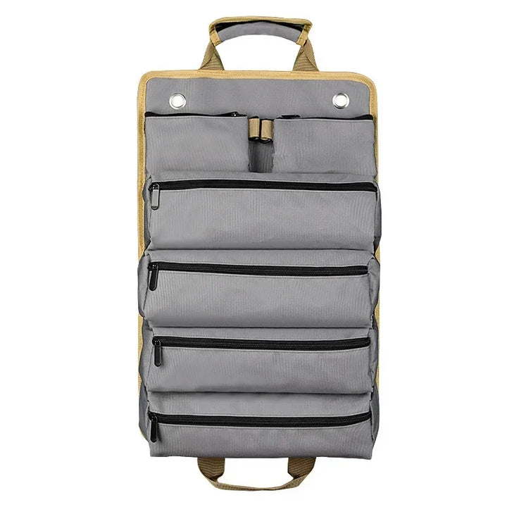 Heavy-duty roll-up tool bag organizer laid flat showing multiple zippered pockets
