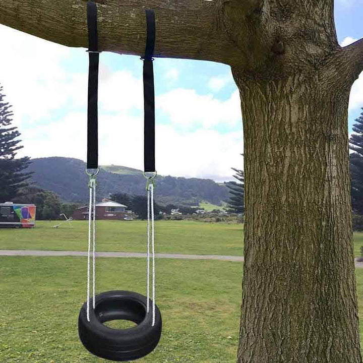 Tree swing hanging straps installed securely on a tree branch holding a tire swing