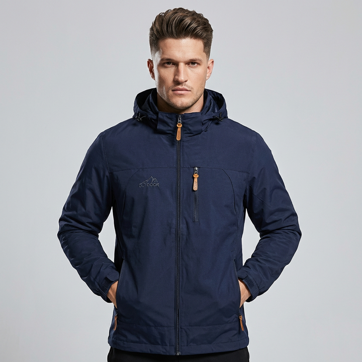 Front view of a man wearing a dark blue waterproof outdoor jacket with hood
