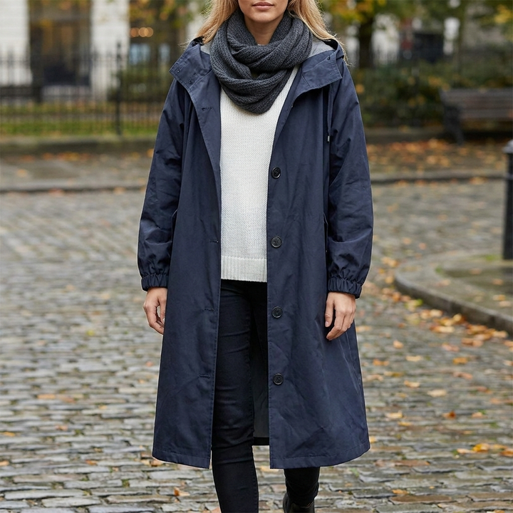 Back view of women's rain gear outerwear with tailored waistline