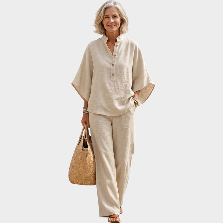 Woman wearing a beige matching two-piece outfit with button-detail top and trousers