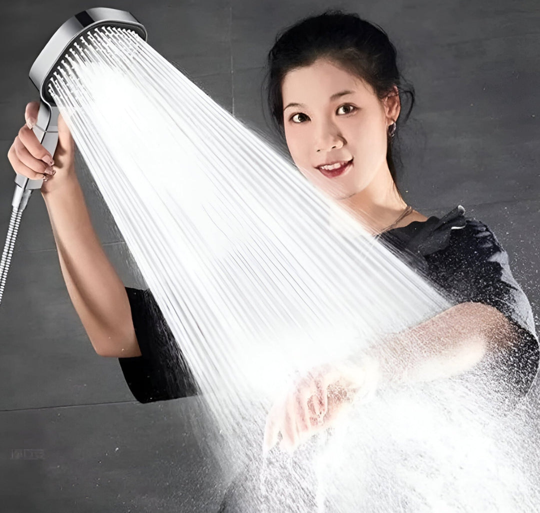 Woman holding the silver high-pressure shower head demonstrating water flow