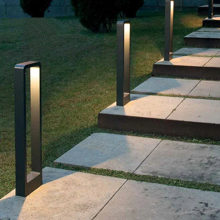 Outdoor garden bollard lights installed along stone steps in a yard