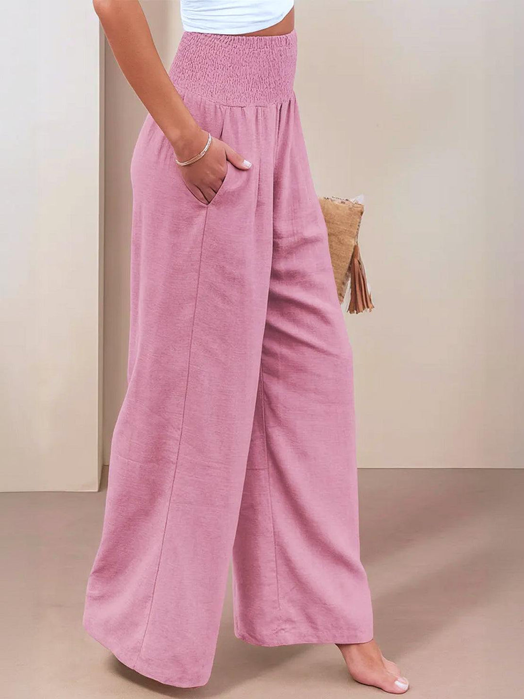 Close up of high waist smocked waistband on wide leg trousers