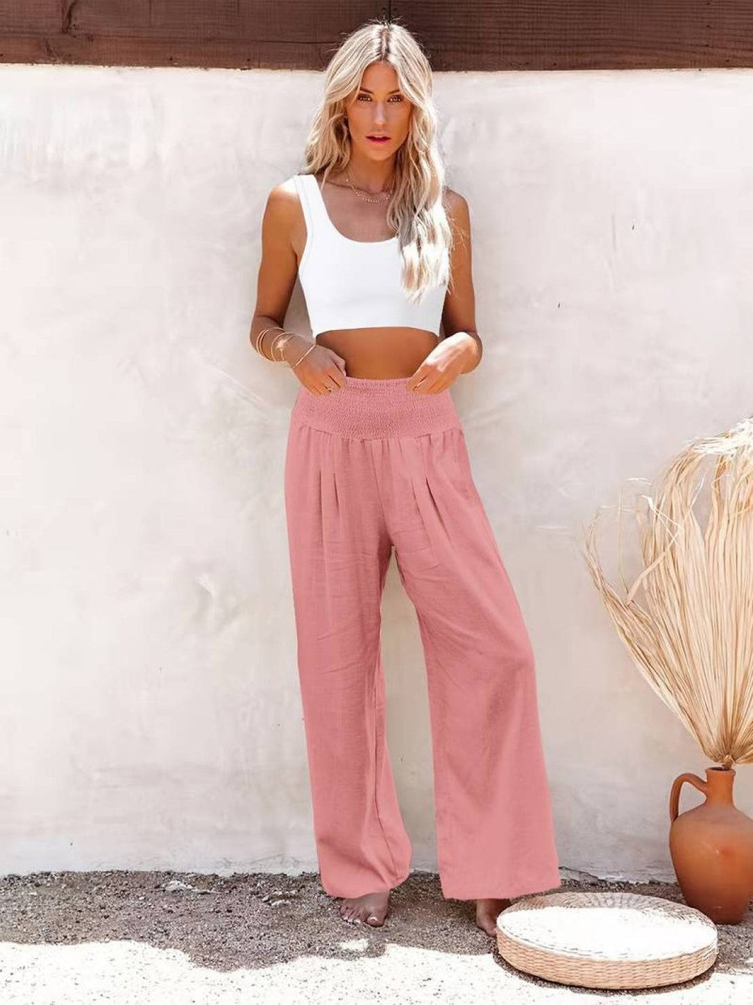 Side profile of flowy wide leg trousers showing elegant drape