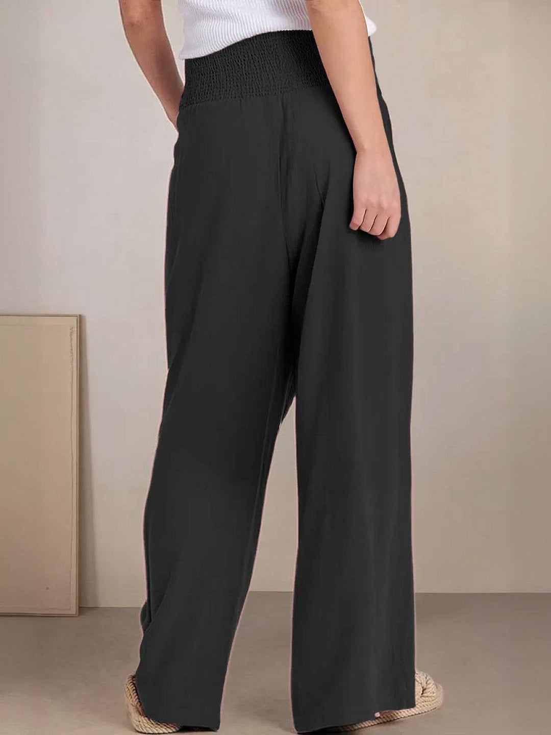 Hems and draping movement of lightweight wide leg trousers