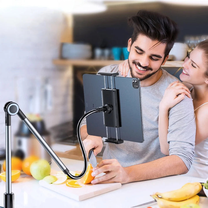 Couple in a kitchen watching a tablet secured on a handsfree desk mount
