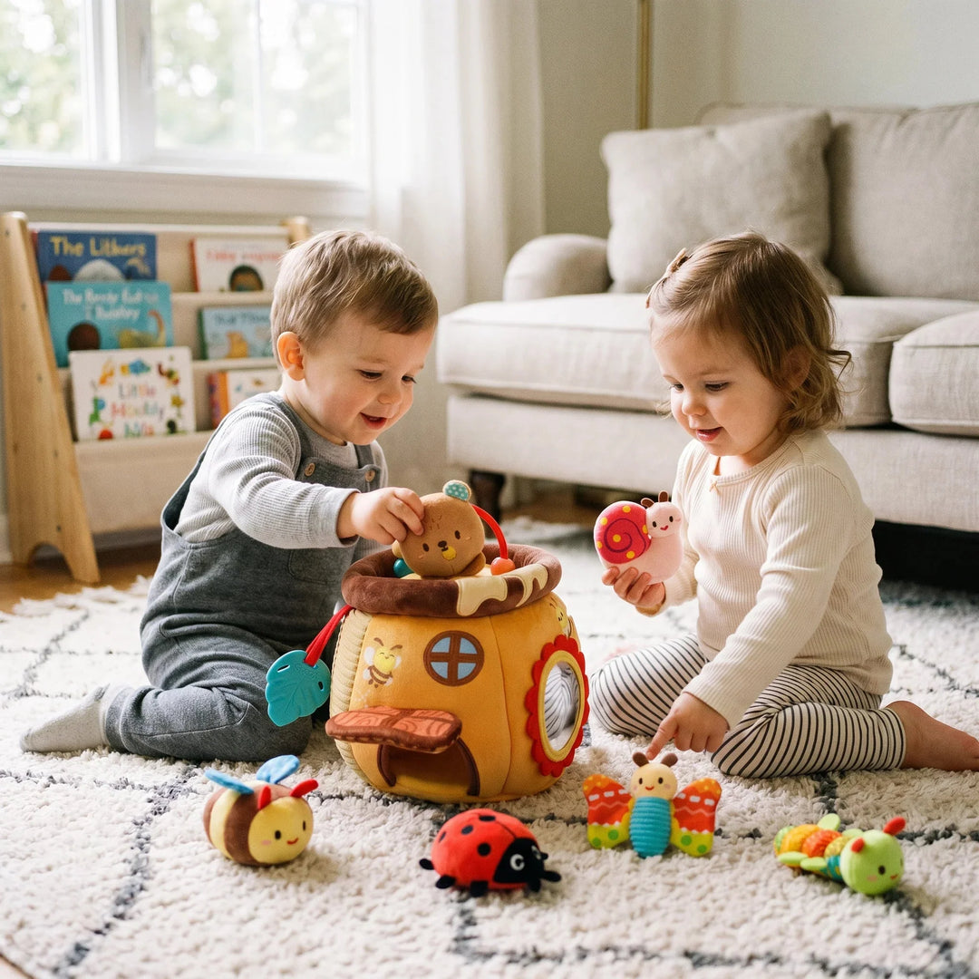 Two toddlers playing together with the plush honey pot toy set on a rug