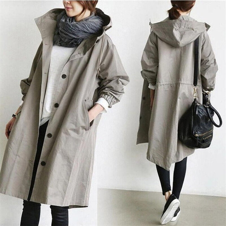 Womens hooded rain trench coat folded neatly, travel outerwear