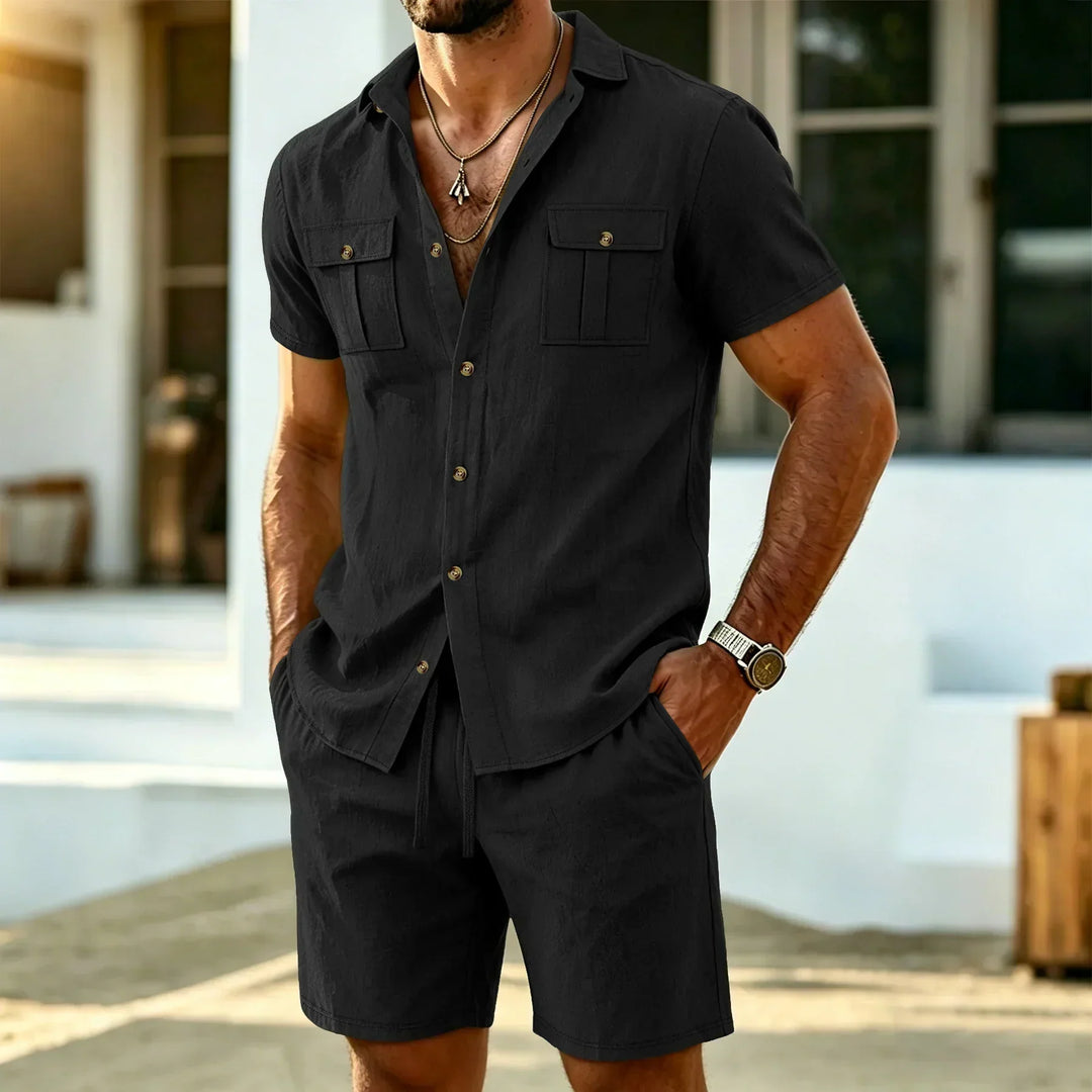 Man wearing black short sleeve shirt and shorts two-piece set outdoors