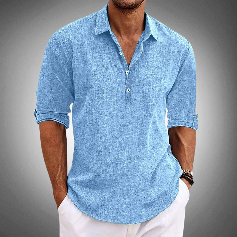 Man wearing a light blue textured long sleeve shirt with half-button placket