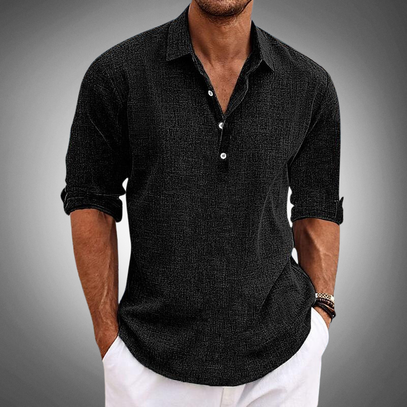 Man wearing a black textured long sleeve shirt with rolled sleeves