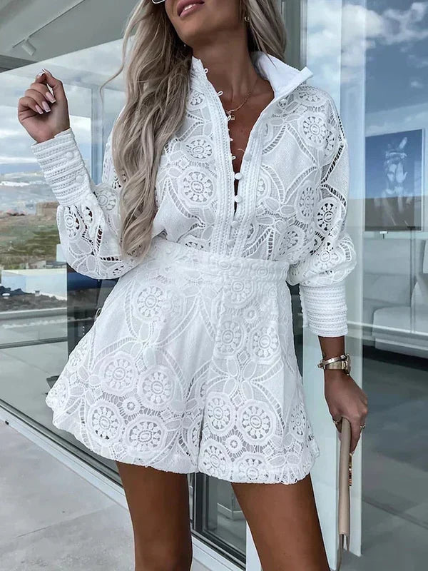 Woman wearing a white two-piece summer outfit with intricate patterns