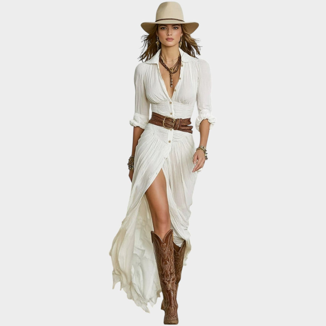 Model wearing a white boho maxi dress with front slit and cowboy boots