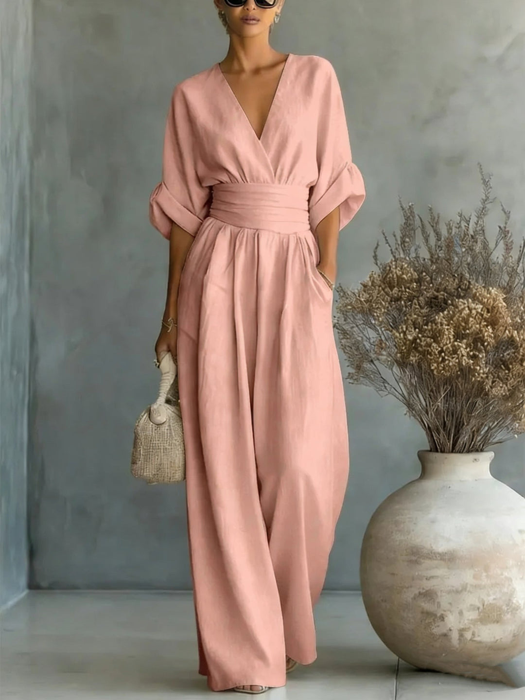 Detailed view of the adjustable tie waist on the wrap jumpsuit