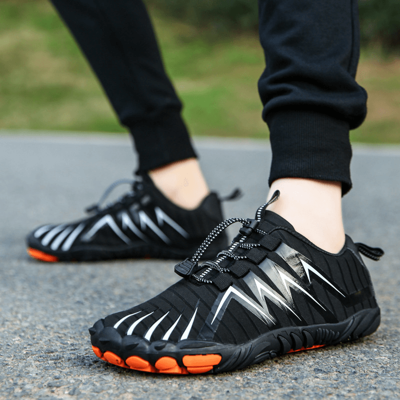 Flexible barefoot outdoor shoes bending easily to demonstrate sole mobility.