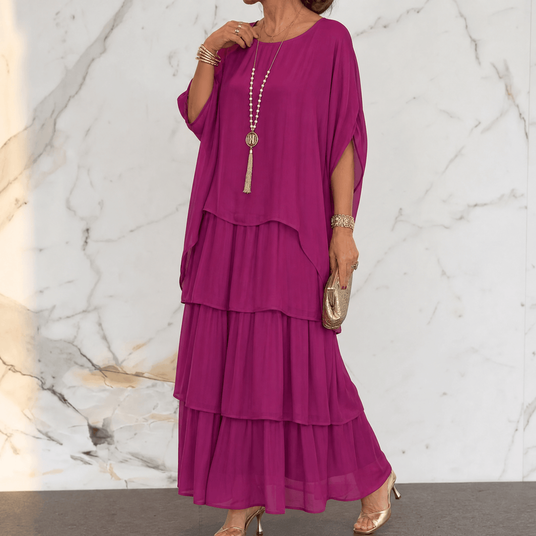 Angled view of flowing batwing sleeve chiffon dress