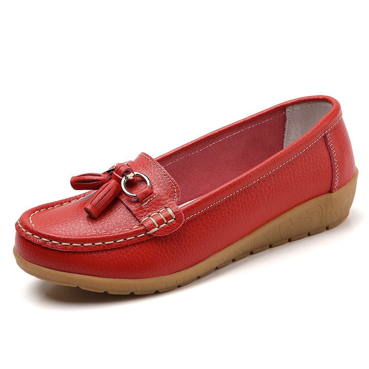 Angled shot of women's leather tassel loafers showcasing classic flat design