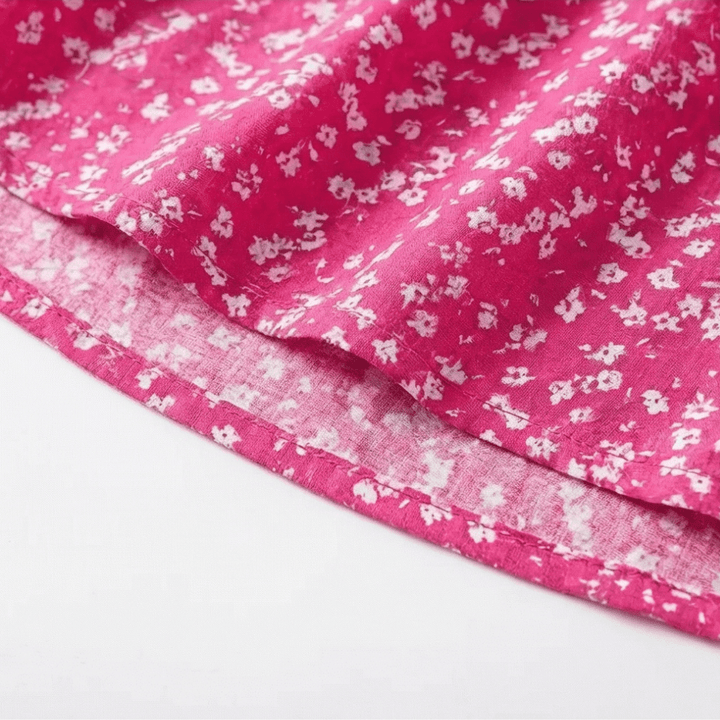 Hemline detail of flowing swing mini dress in floral pattern