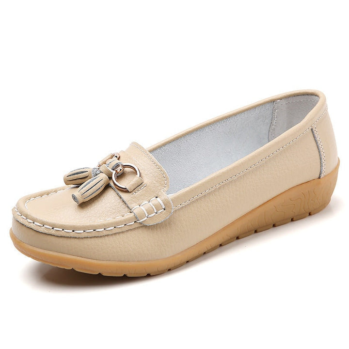 Model wearing women's comfort tassel loafers with casual trousers