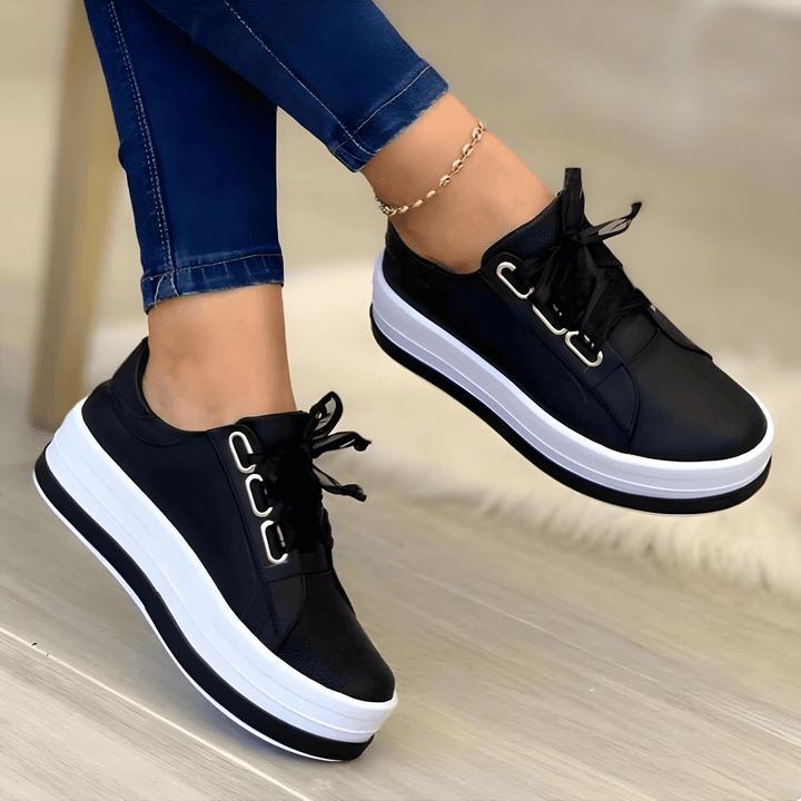 Black women's platform sneakers paired with blue jeans
