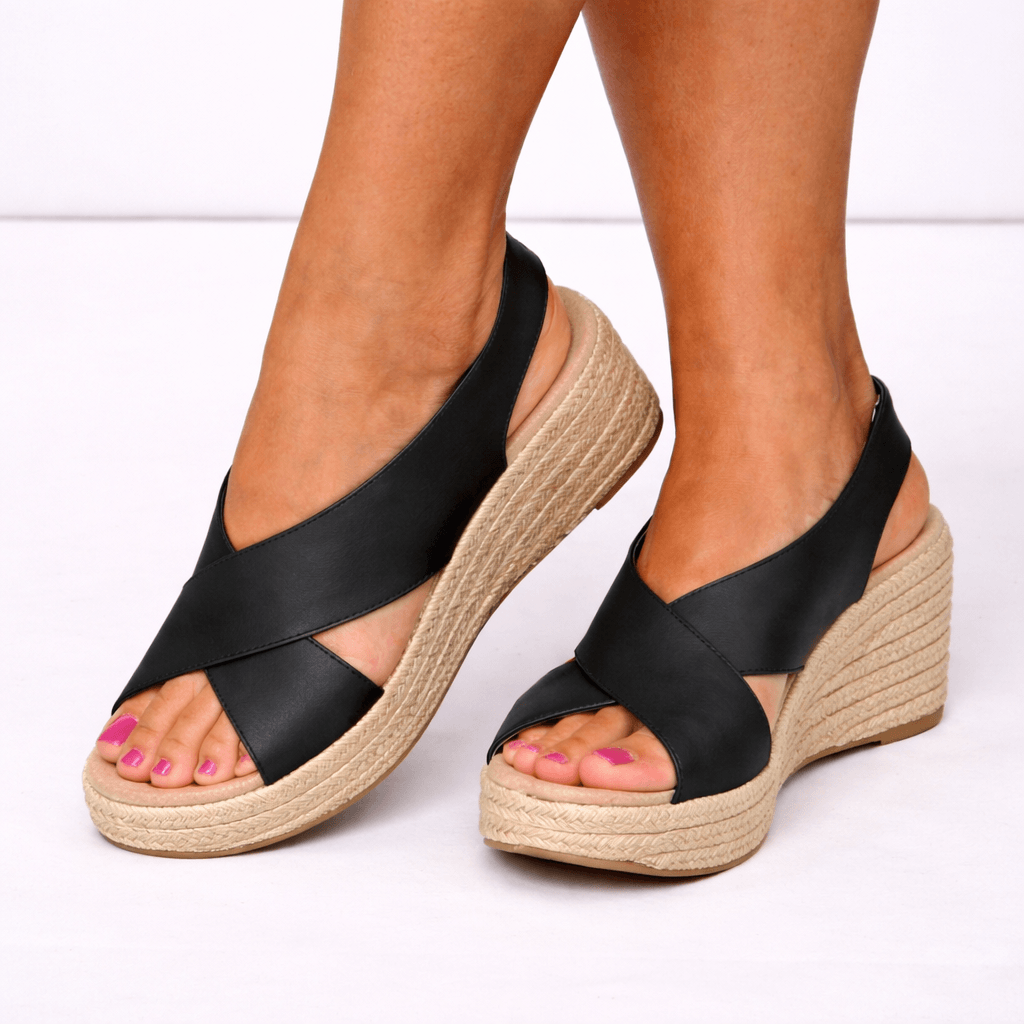 Women wearing black orthopedic espadrille wedge sandals with crossover straps