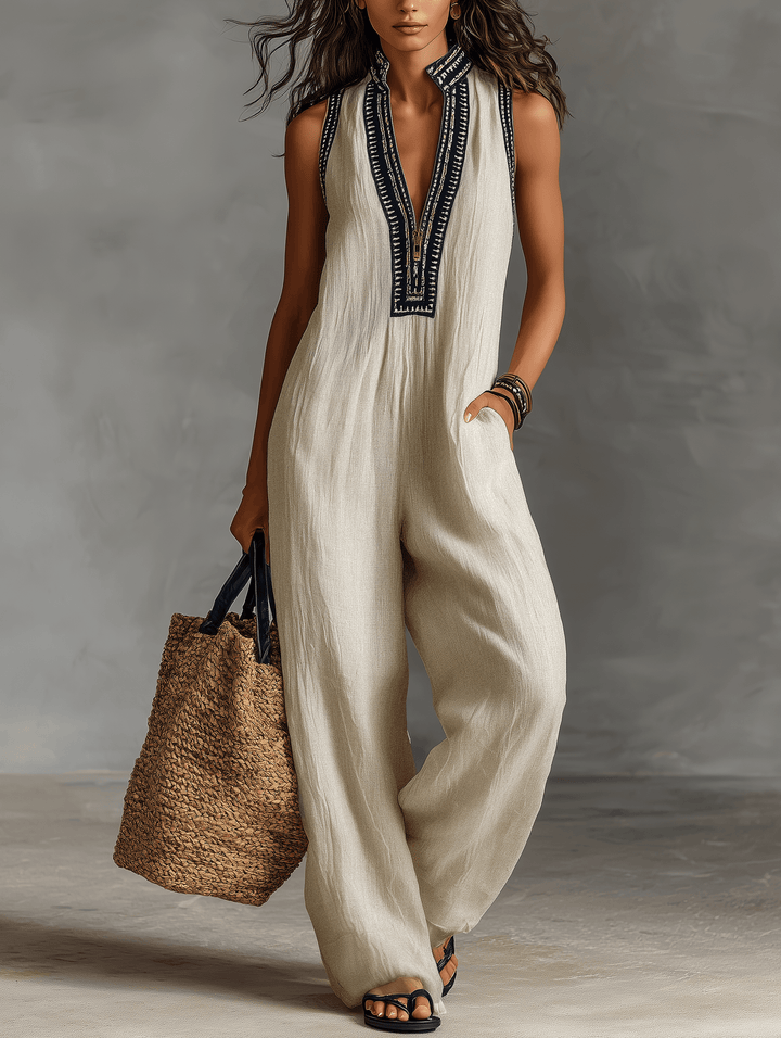 Model wearing women's embroidered sleeveless jumpsuit in neutral photo color with wide legs