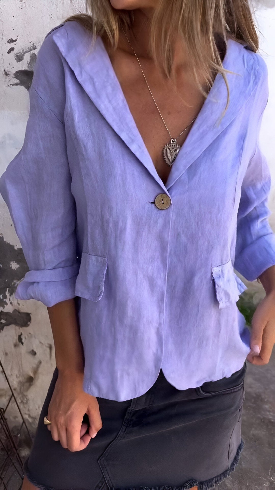 Woman wearing a light purple tailored jacket with notched lapel and front button