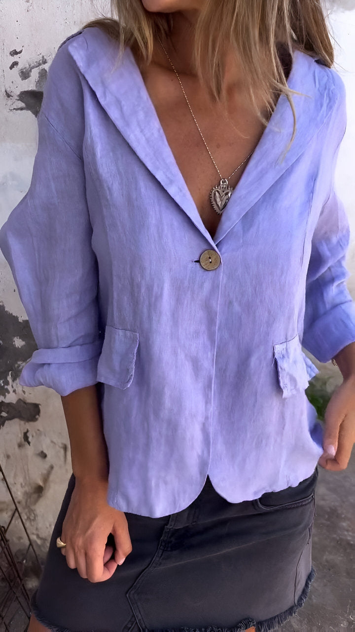 Woman wearing a light purple tailored jacket with notched lapel and front button
