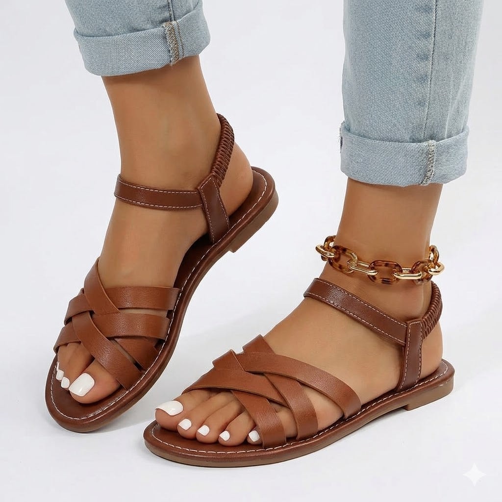 Close-up of a person wearing brown woven orthopedic sandals with ankle strap
